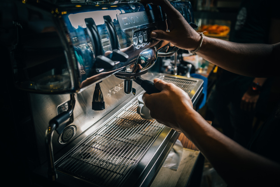 A barista making coffee at the espresso machine