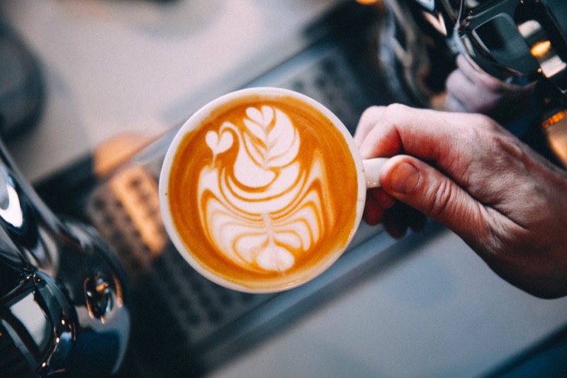 A barista pouring latte art