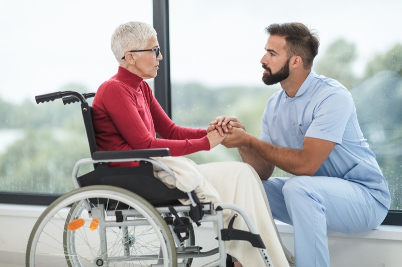 A carer holding hands with an older client