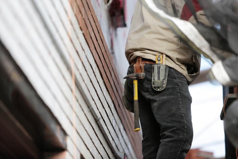 A tradesperson wearing a tool belt